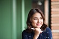 Young beautiful woman in the cafe near the window, thinking and writing something Royalty Free Stock Photo