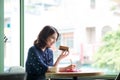 Young beautiful woman in the cafe near the window, thinking and Royalty Free Stock Photo