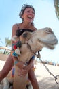 Young beautiful woman with a camel on the beach Royalty Free Stock Photo