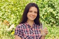 Young beautiful woman in casual shirt holds a glass of water and Royalty Free Stock Photo