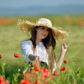 Young beautiful woman on cereal field with poppies in summer Royalty Free Stock Photo