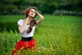 Young beautiful woman on cereal field with poppies in summer Royalty Free Stock Photo