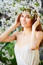 Young beautiful woman in circlet of flowers