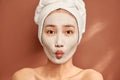 Young beautiful woman with clay face mask. Spa treatment, self care and healthy skin Royalty Free Stock Photo