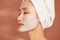 Young beautiful woman with clay face mask. Spa treatment, self care and healthy skin Royalty Free Stock Photo