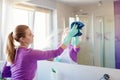 Young beautiful woman in cleaning mirror in bathroom Royalty Free Stock Photo