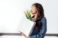 Young beautiful woman closed her eyes and smells bouquet of flowers with pleasure Royalty Free Stock Photo