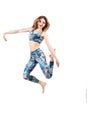 Young beautiful woman in color-blue top and leggings jumping of joy. Young sporty fit emale model isolated on white background in Royalty Free Stock Photo