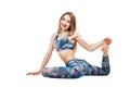 Young beautiful woman in color-blue top and leggings yoga posing isolated over white studio background and looking at camera. Royalty Free Stock Photo