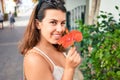 Young beautiful woman at the colorful village of Puerto de Mogan, smiling happy smelling flower on the street on summer holidays Royalty Free Stock Photo