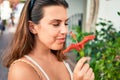 Young beautiful woman at the colorful village of Puerto de Mogan, smiling happy smelling flower on the street on summer holidays Royalty Free Stock Photo