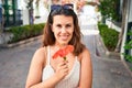 Young beautiful woman at the colorful village of Puerto de Mogan, smiling happy smelling flower on the street on summer holidays Royalty Free Stock Photo