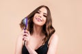 Young beautiful woman combing brown hair. Hair Care. Beautiful brunette woman hairbrushing hair with hairbrush. Brushing Royalty Free Stock Photo