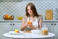 Young beautiful woman cooks tasty wholesome diet food at home Royalty Free Stock Photo