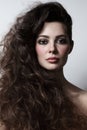 Beautiful woman with curly hair and smoky eye make-up Royalty Free Stock Photo