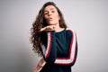 Young beautiful woman with curly hair wearing casual sweater over isolated white background looking at the camera blowing a kiss Royalty Free Stock Photo