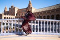 Young and beautiful woman dancing flamenco and Spanish posing in urban clothes, wearing her hair loose and long and standing on