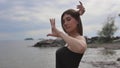 Young beautiful woman dancing on the seashore Royalty Free Stock Photo