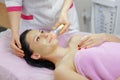 Young beautiful woman with dark hair gets procedure in the beauty salon