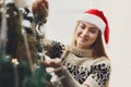 Young beautiful woman decorating christmas tree, new year decora Royalty Free Stock Photo