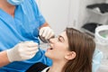 Young beautiful woman in the dentist chair at dental clinic. Medicine, health, stomatology concept. dentist treating a Royalty Free Stock Photo