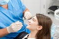 Young beautiful woman in the dentist chair at dental clinic. Medicine, health, stomatology concept. dentist treating a Royalty Free Stock Photo