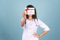 Young beautiful woman doctor in a lab coat on a blue background Royalty Free Stock Photo