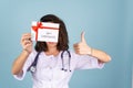 Young beautiful woman doctor in a lab coat on a blue background Royalty Free Stock Photo