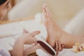 Young Beautiful Woman Does Pedicure in Spa Salon.