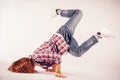 Young beautiful woman doing an element of breakdance dancing hip