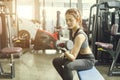 Young beautiful woman doing exercises with dumbbell in gym. Royalty Free Stock Photo