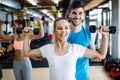 Young beautiful woman doing exercises with personal trainer Royalty Free Stock Photo