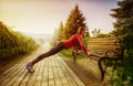 Young beautiful woman doing fitness in a park. Royalty Free Stock Photo