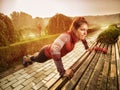 Young beautiful woman doing fitness in a park. Royalty Free Stock Photo