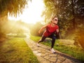 Young beautiful woman doing fitness in a park. Royalty Free Stock Photo