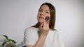 Young beautiful woman doing makeup. The girl applies powder with make up brush. Royalty Free Stock Photo