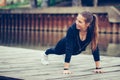 Young beautiful woman doing push up outdoors Royalty Free Stock Photo