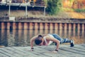 Young beautiful woman doing push up outdoors Royalty Free Stock Photo