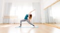 Young beautiful woman doing yoga in bright spacious studio Royalty Free Stock Photo