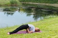 Young beautiful woman doing yoga exercise in green park. Healthy lifestyle and fitness concept. Royalty Free Stock Photo