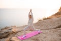 Young beautiful woman doing yoga pose wear sport suit practice over nature sea background. Healthy lifestyle. Royalty Free Stock Photo