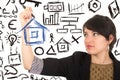 Young beautiful woman drawing a house with marker Royalty Free Stock Photo