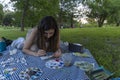 Young beautiful woman drawing a painting outdoors, talented artist with a palette Royalty Free Stock Photo