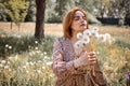 Young Beautiful Woman Holding Bunch Of Dandelion Flowers Standing On Meadow Royalty Free Stock Photo