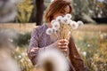 Young Beautiful Woman Holding Bunch Of Dandelion Flowers Standing On Meadow Royalty Free Stock Photo