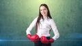 Young beautiful woman dress in white shirt standing in combat pose with red boxing gloves. Business concept. Royalty Free Stock Photo