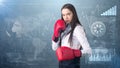 Young beautiful woman dress in white shirt standing in combat pose with red boxing gloves. Business concept. Royalty Free Stock Photo