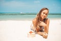 Young beautiful woman drinking coconut water on tropical beach Royalty Free Stock Photo