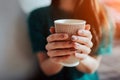 Young beautiful woman drinking coffee at cafe bar. Female model in the morning at restaurant Royalty Free Stock Photo