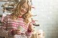 Young beautiful woman drinking cup of coffee blurred winter snow tree background. Royalty Free Stock Photo